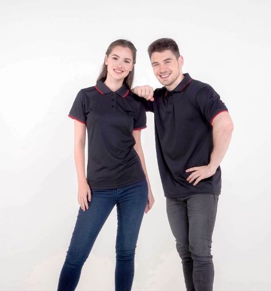 A man and a woman wearing polo shirt uniforms