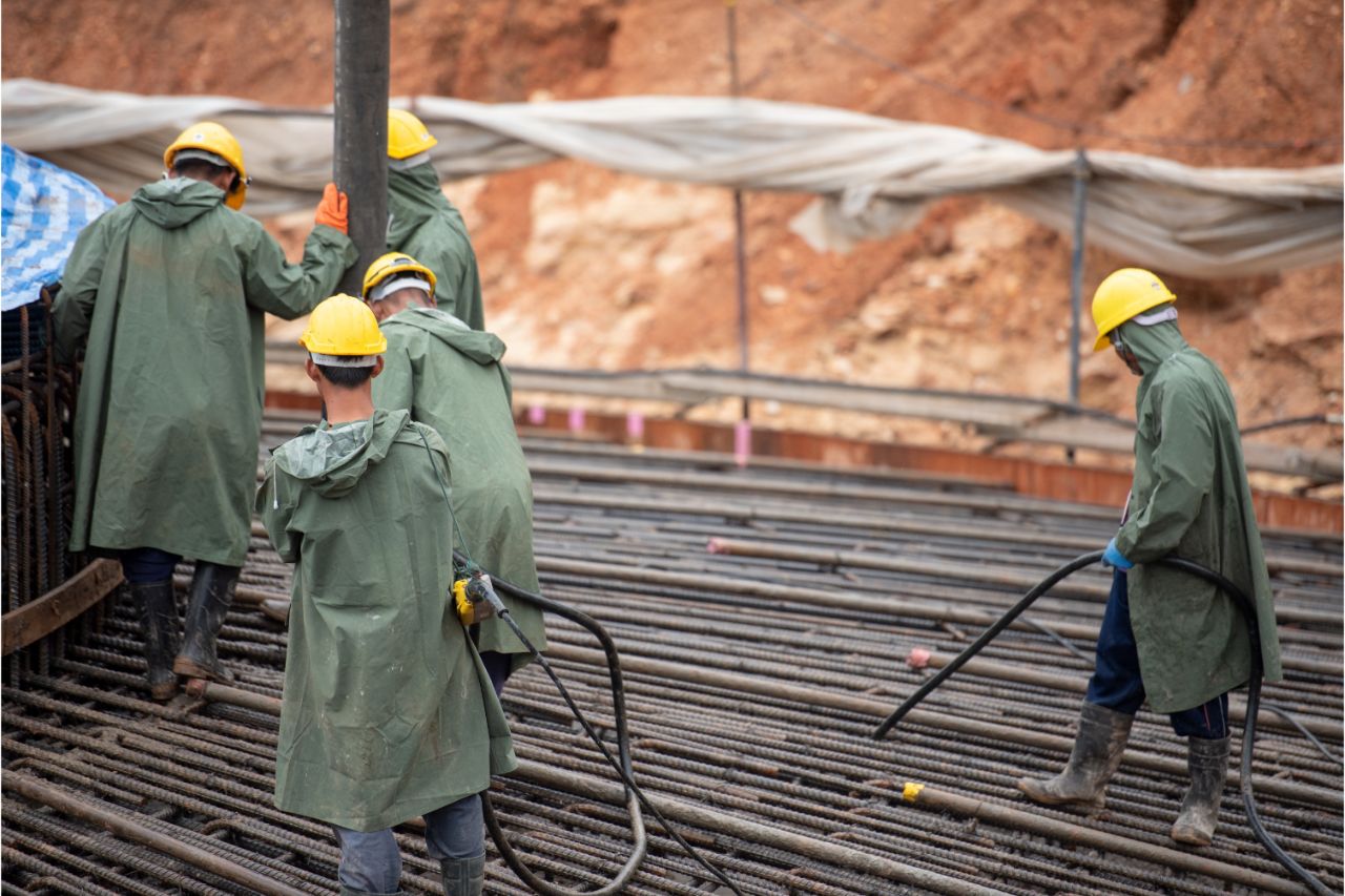 Construction workers wearing raincoats
